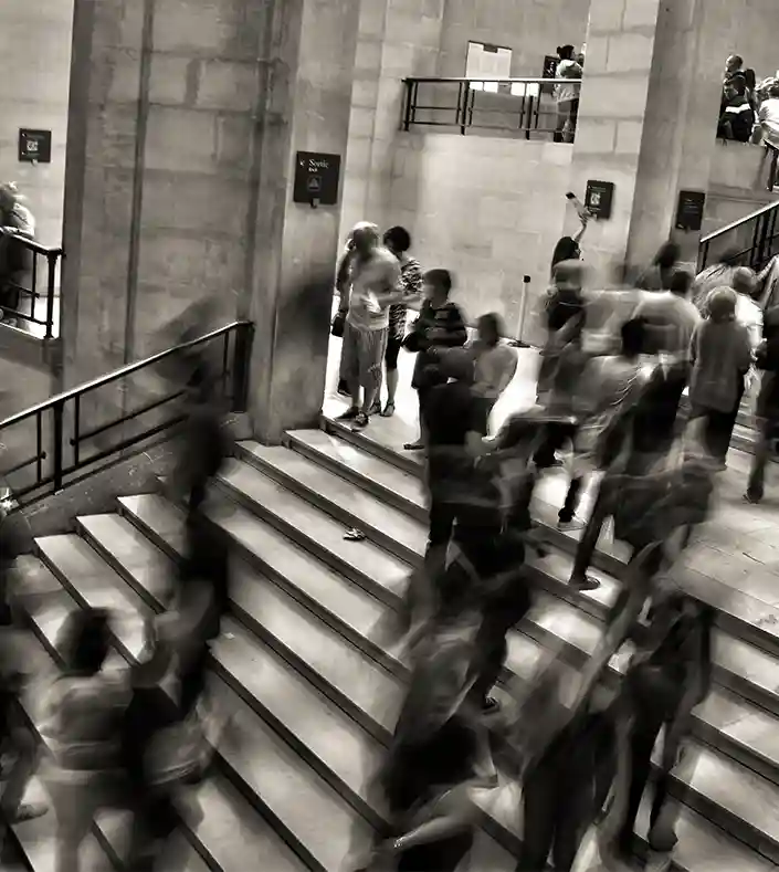 People in motion going up and down stairs.